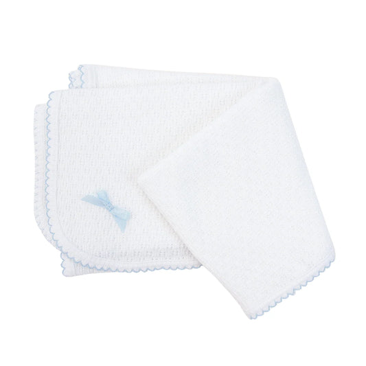 white baby blanket with light blue trim and small bow