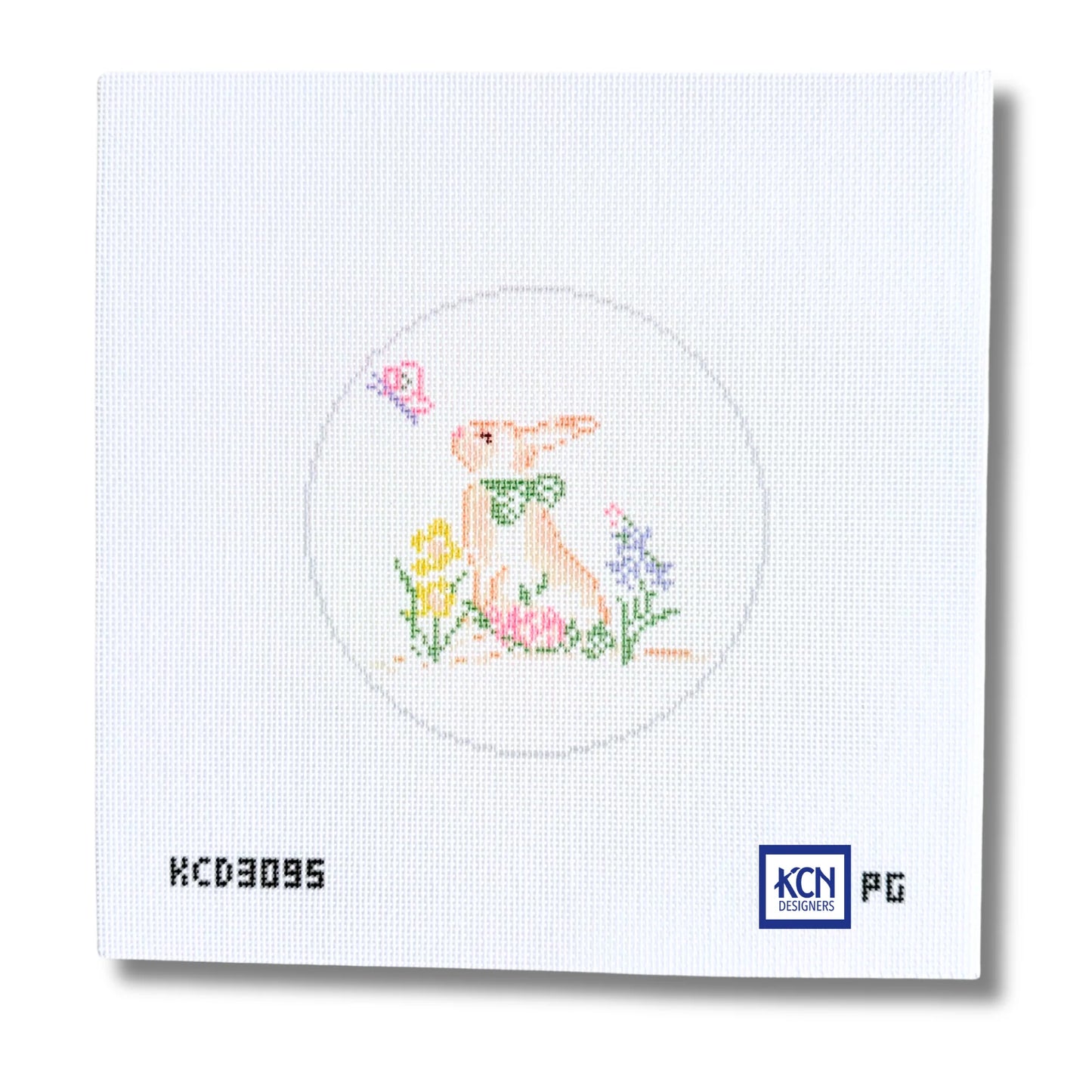 A square white needlepoint canvas featuring a stitched design of a rabbit in a circle with flowers and a butterfly. The canvas includes printed text 'KCD3095' on the bottom left and a 'KCN Pictoric' logo on the bottom right.