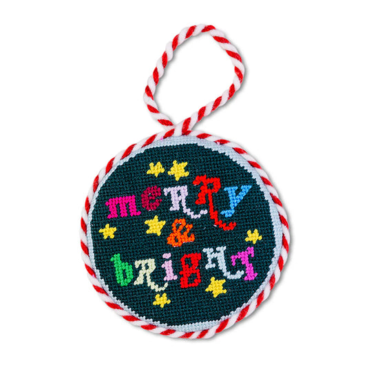 Round embroidered ornament with 'Merry & Bright' text on a white background