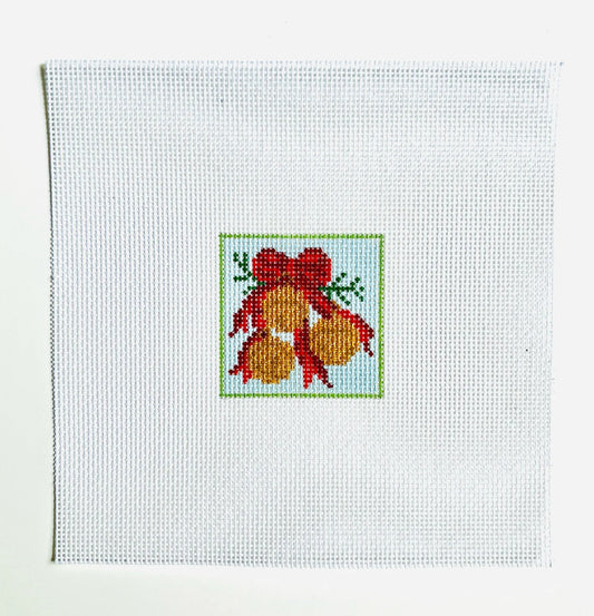 Cross-stitched design of a red bow with gold balls on white fabric