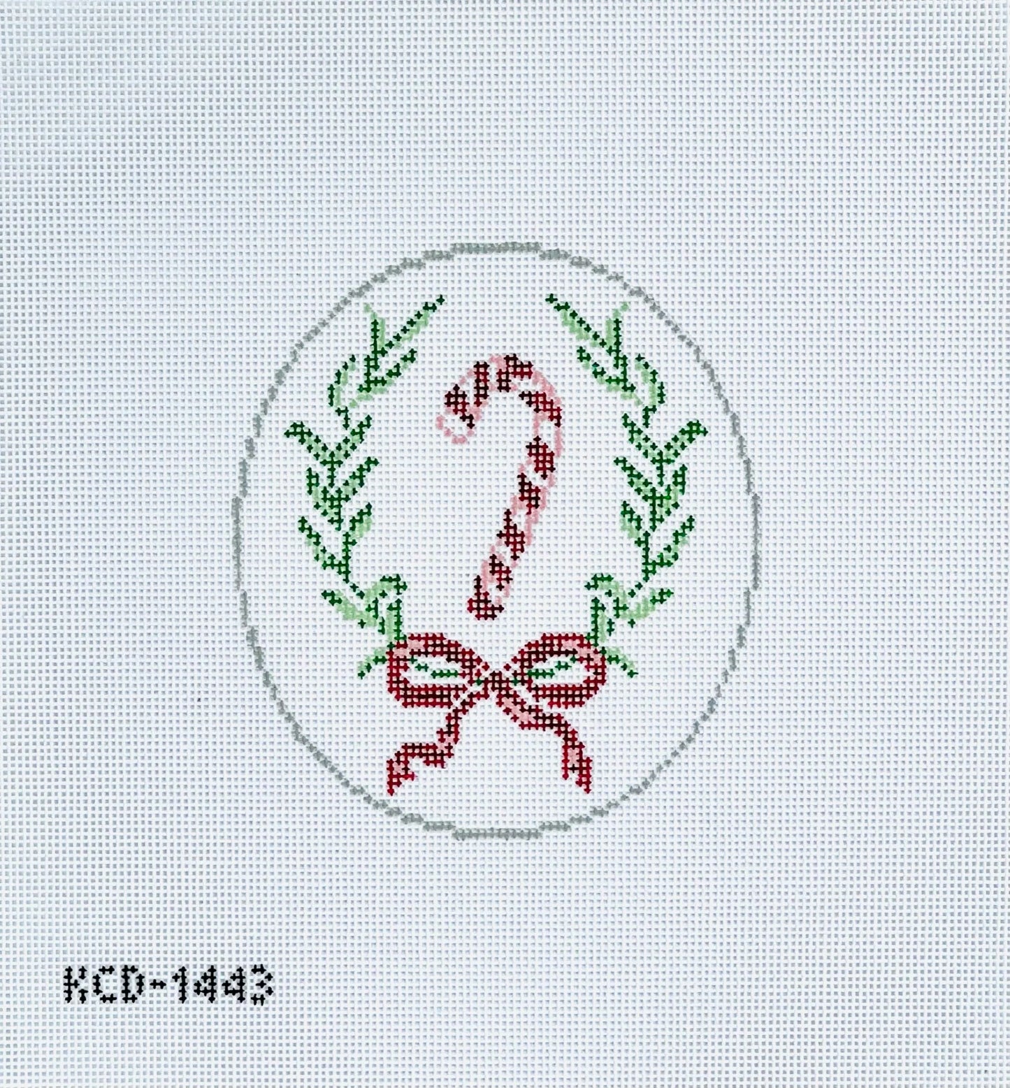 Cross-stitched design of a candy cane and bow with greenery on a light gray background.