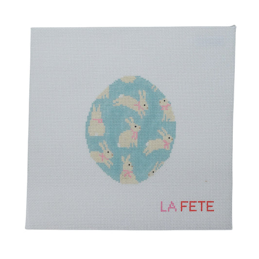 Canvas with a blue Easter egg design featuring bunnies and 'La Fete' branding on a light gray background.