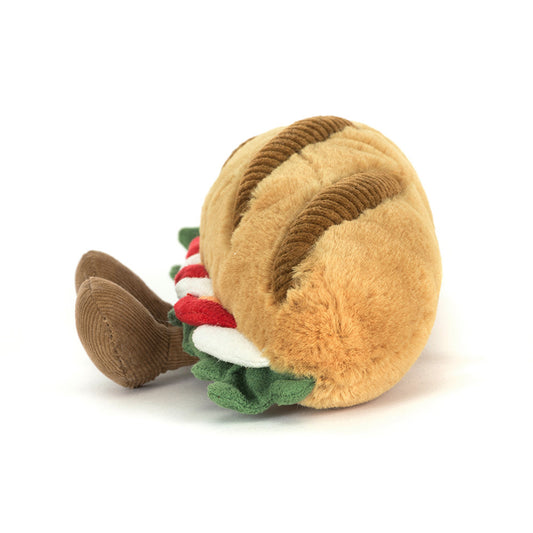 Plush toy resembling a hot dog with bun on a white background