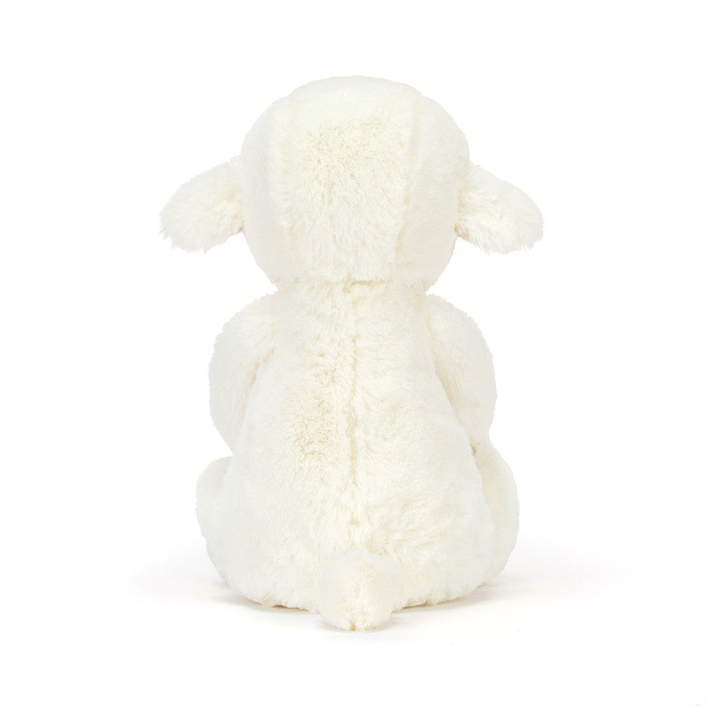 White plush lamb toy on a white background