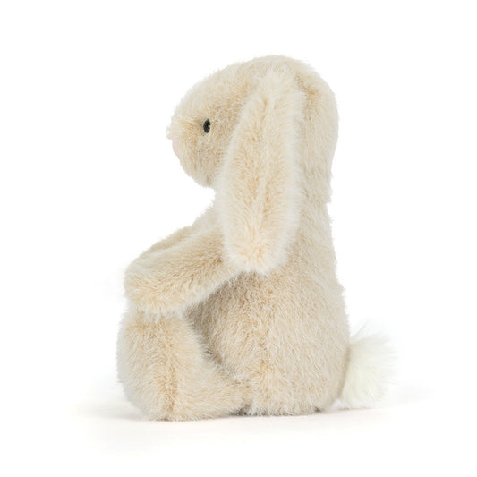 Fluffy beige bunny plush toy on a white background