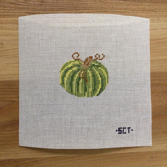 Cross-stitched green pumpkin on a white fabric background with 'SCT' branding.