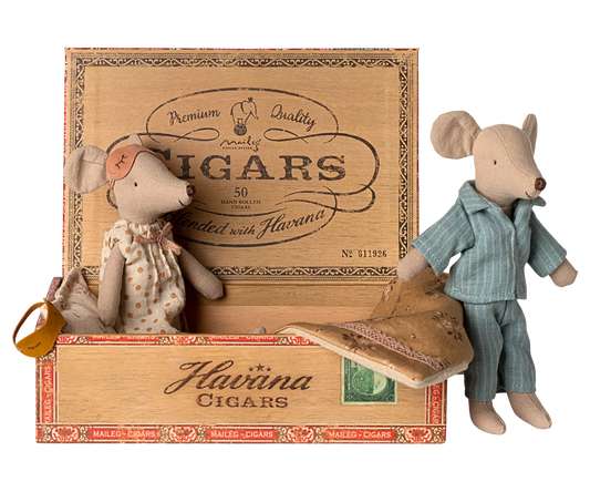 Two toy mice in a wooden Havaina Cigars box on a white background