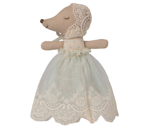 Stuffed animal toy with a lace dress on a white background