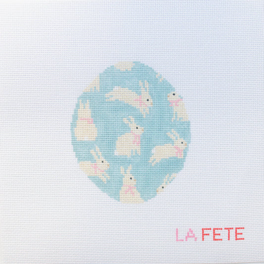 needlepoint design of bunnies on a blue background with 'La Fete' branding.