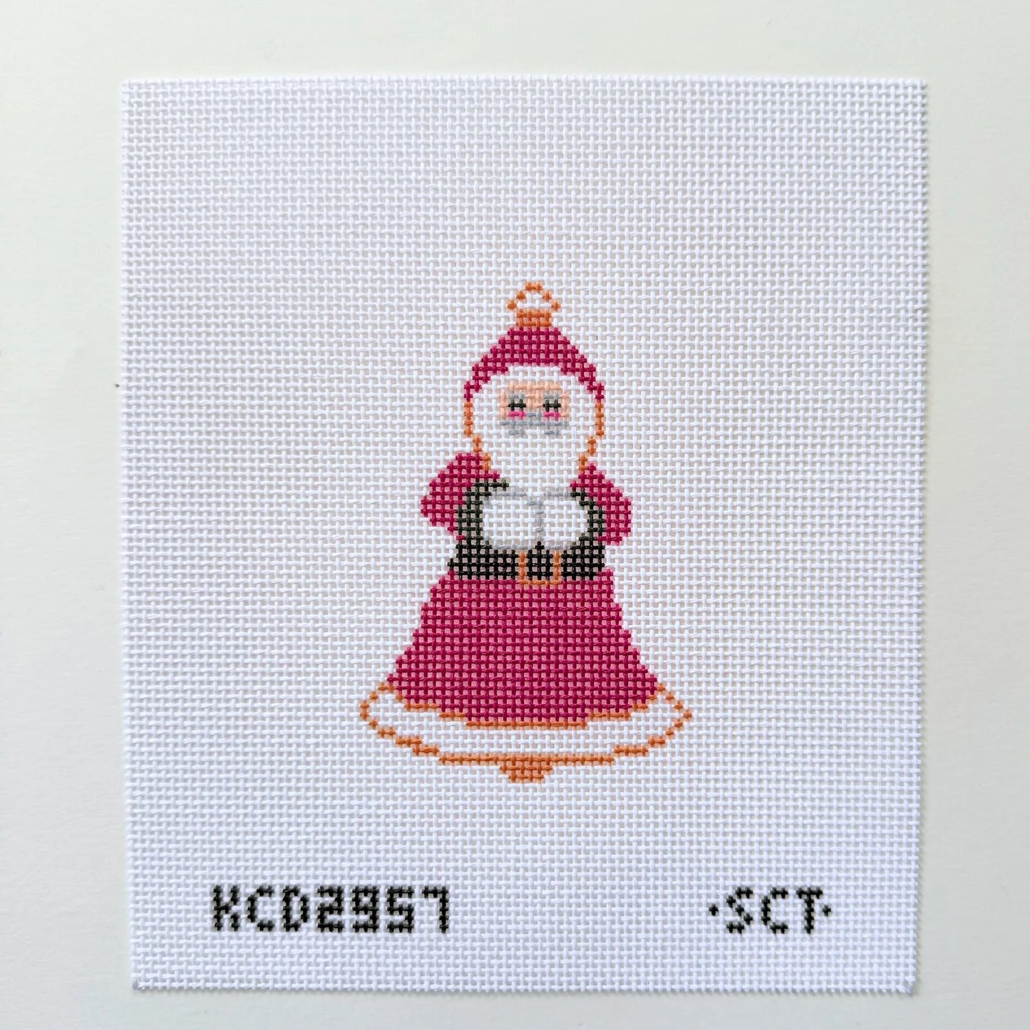 Cross-stitched pattern of a character in a red dress with a white background