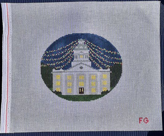 needlepoint canvas with white building and christmas lights