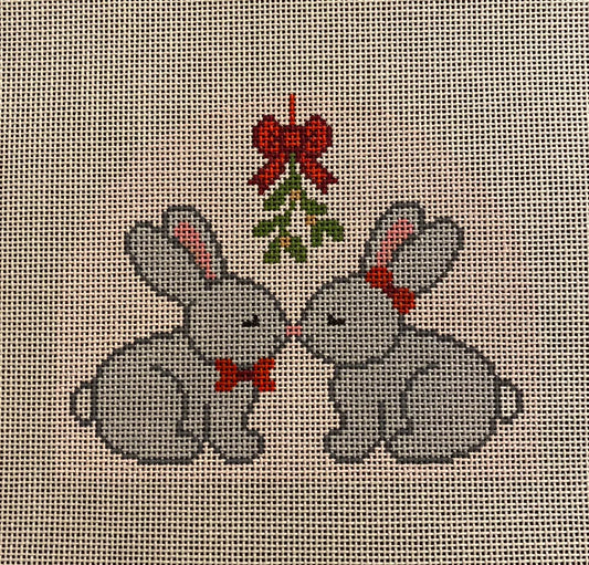Two gray rabbits with red bows and a holly berry tree on a cross-stitched background