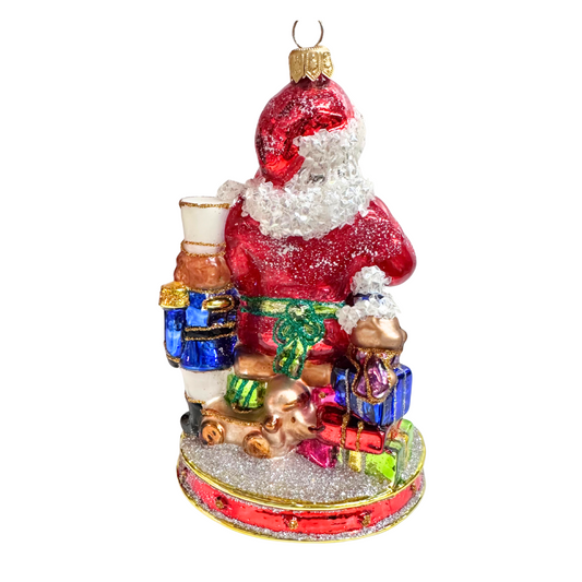 Decorative Christmas ornament of Santa Claus with gifts on a white background