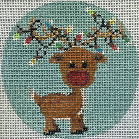 Cross-stitched reindeer with floral antlers on a light blue fabric background