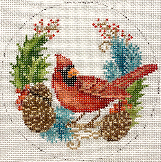 Cross-stitched design of a cardinal bird with winter elements on a white background