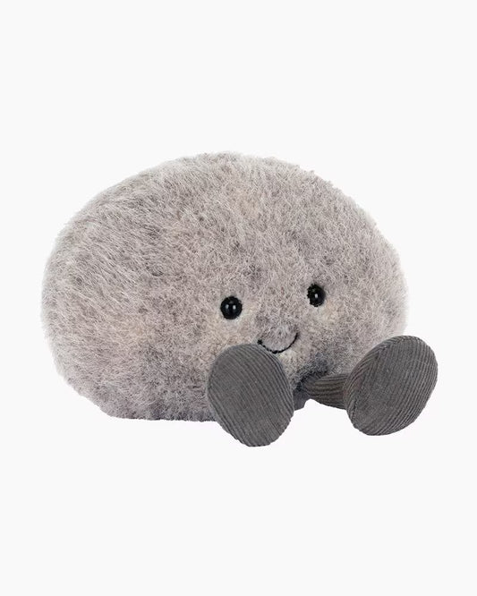 Plush toy whale with a bow tie on a white background