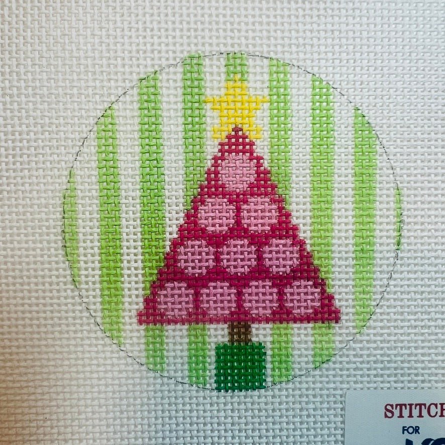 needlepoint design showing a pink tree with pink polka dots on a green and white striped background