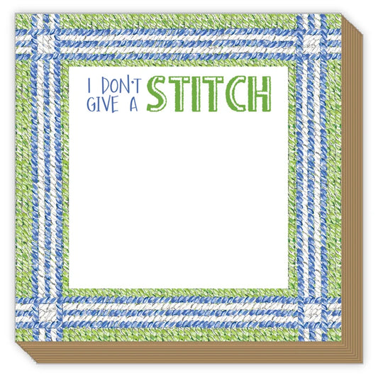 A square paper napkin or coaster with a white center and a decorative border. The border has a stitched-look pattern in blue and green, with the text 'I DON'T GIVE A STITCH' printed at the top.