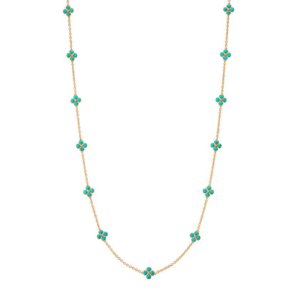Gold necklace with turquoise stones on a white background