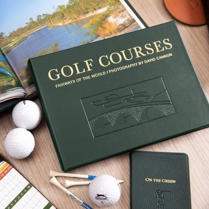 Golf-themed book titled 'Golf Courses' with golf balls and tees on a wooden surface