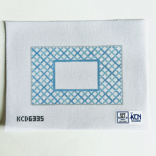 Cross-stitch pattern on fabric with blue and white design, KCDN logo visible