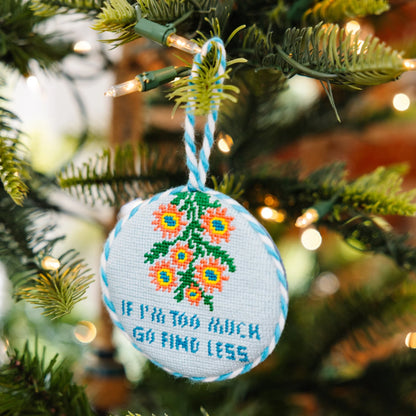 Decorative ornament with floral pattern and text on a Christmas tree
