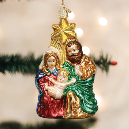 Decorative Christmas ornament of the Holy Family on a blurred Christmas tree background