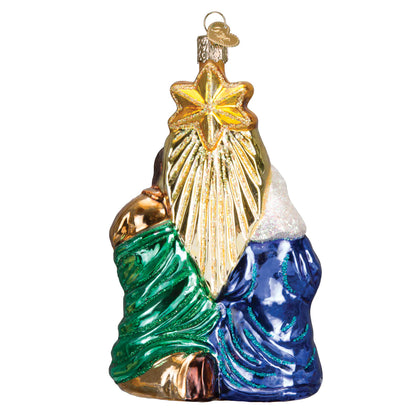 Decorative glass ornament with a star, green and blue elements on a white background