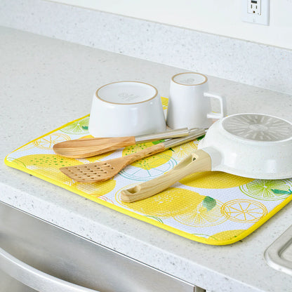 Kitchen counter with a yellow and white dish towel, wooden utensils, and ceramic items.