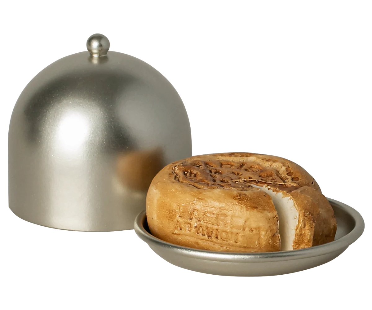 Cheese wheel with a dome cover on a white background