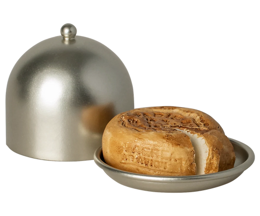 Cheese wheel with a dome cover on a white background