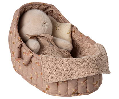 Textile basket with soft, fluffy items on a white background