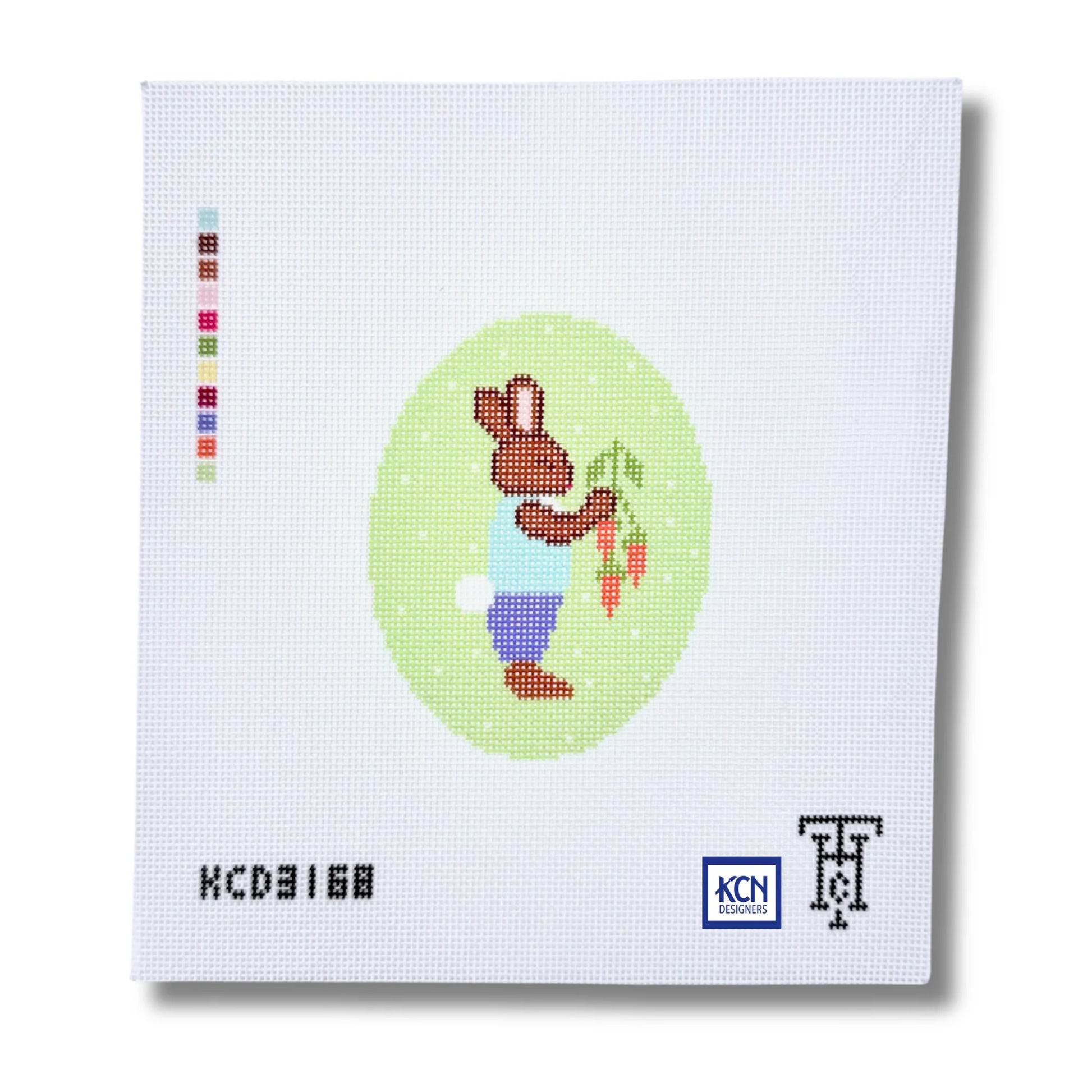 Cross-stitched bunny design on a white fabric with visible brand logos.
