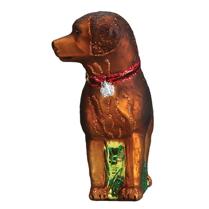 Decorative dog ornament with a red collar and green base on a white background