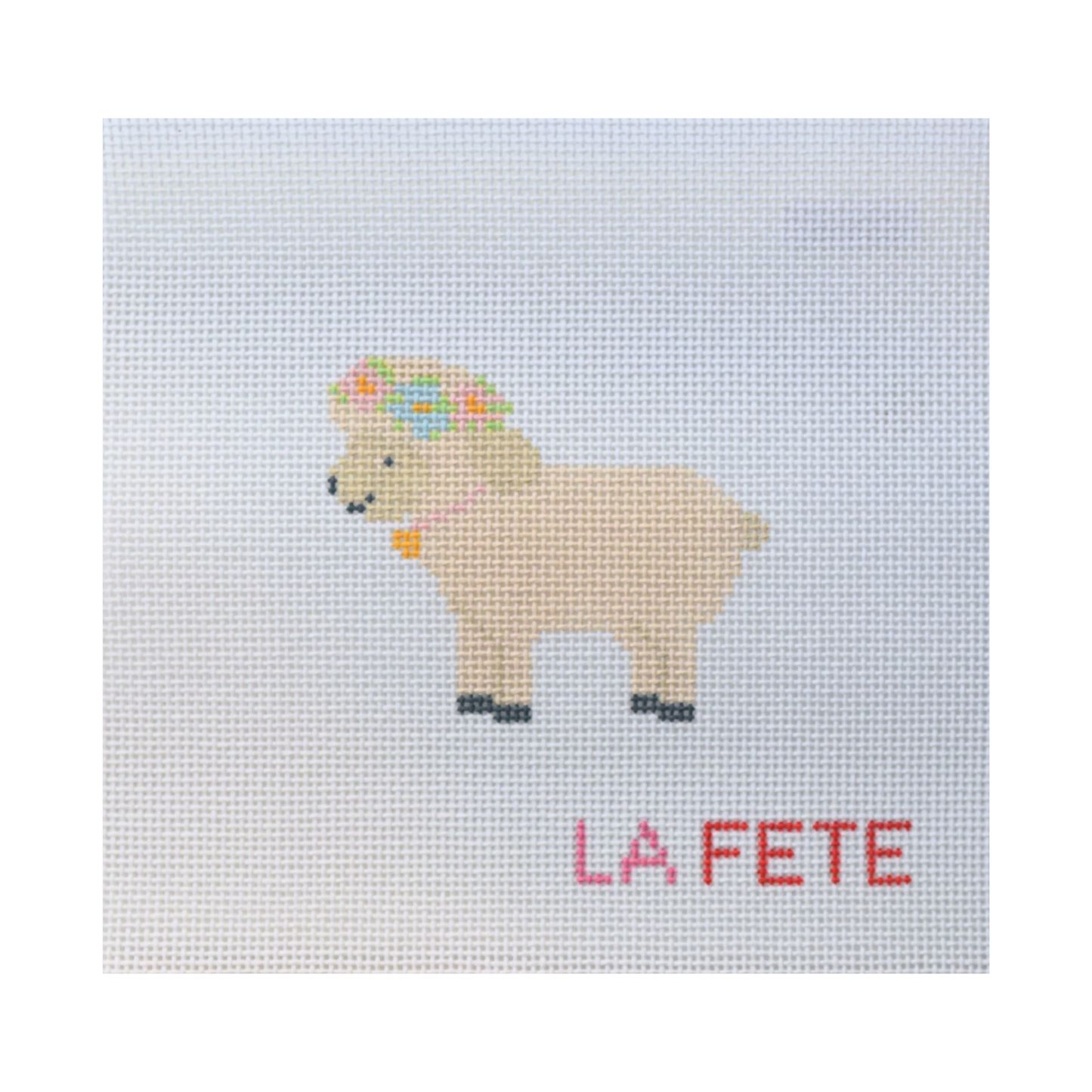 needlepoint  sheep design with 'LA FETE' text on a light blue background