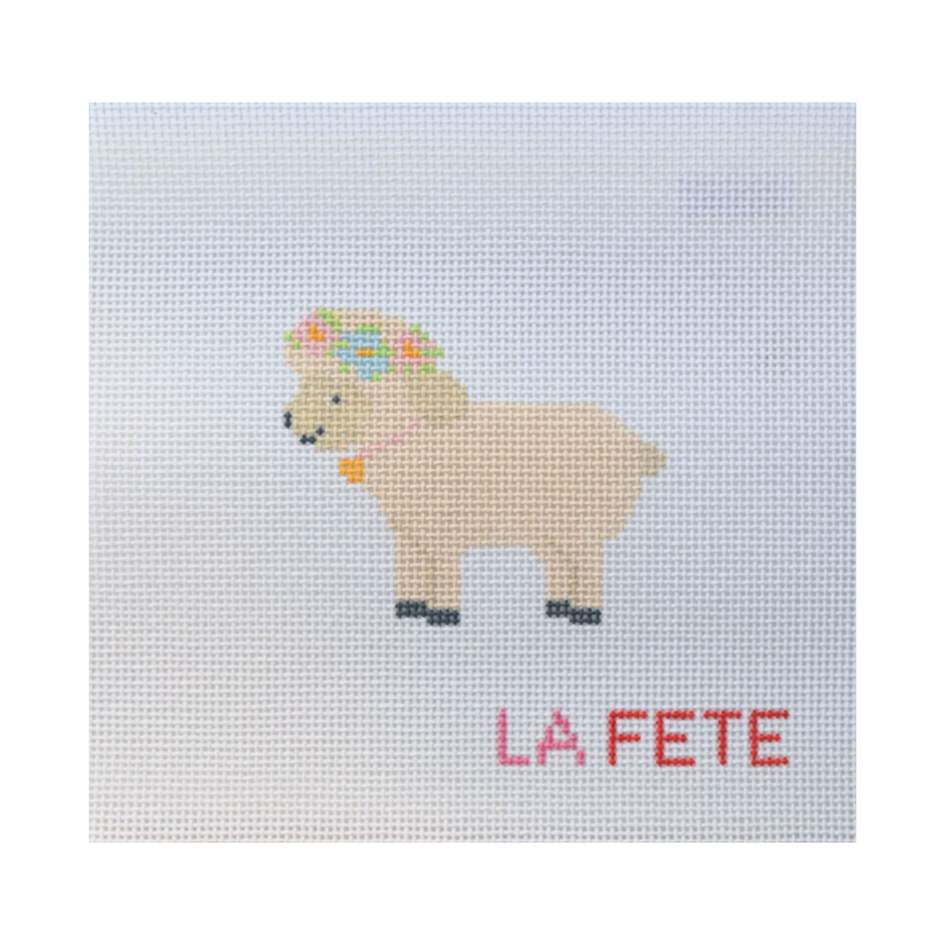 needlepoint  sheep design with 'LA FETE' text on a light blue background