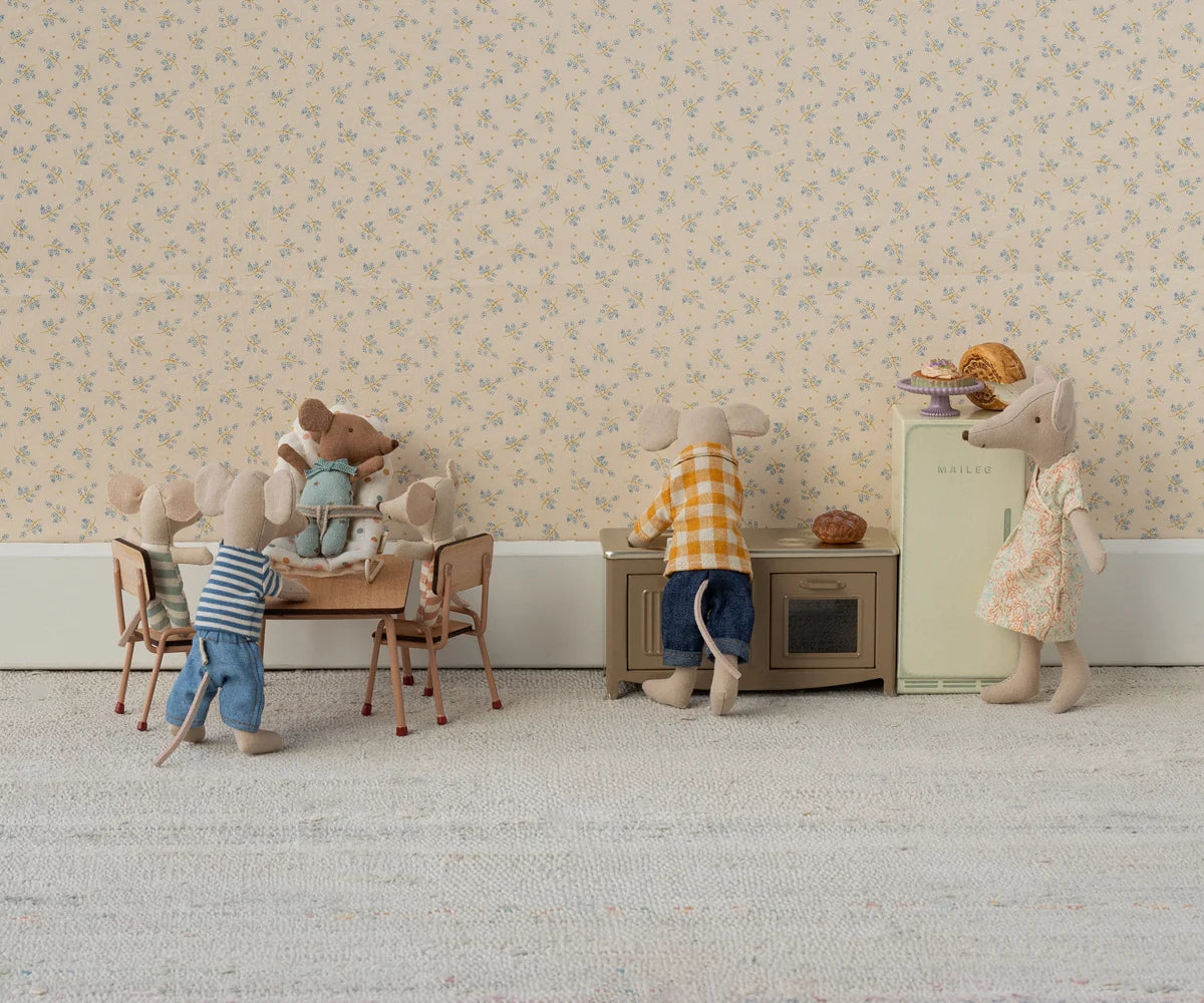 Miniature mouse family in a living room setting with furniture and decor.