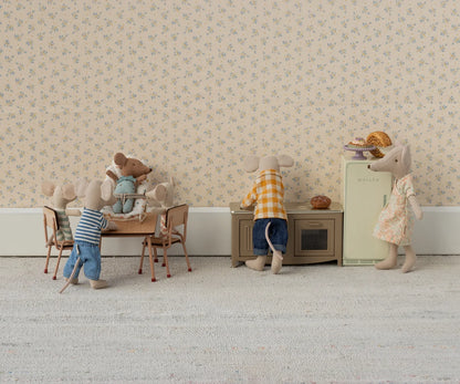 Miniature mouse family in a living room setting with furniture and decor.