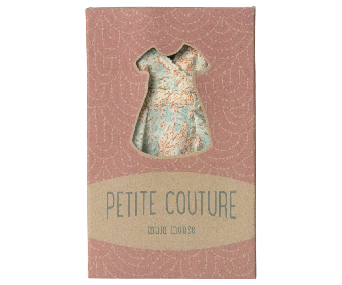 Small dress-shaped object on a 'Petite Couture' box with a pink and beige design.