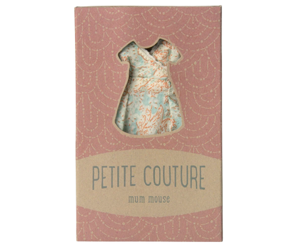 Small dress-shaped object on a 'Petite Couture' box with a pink and beige design.