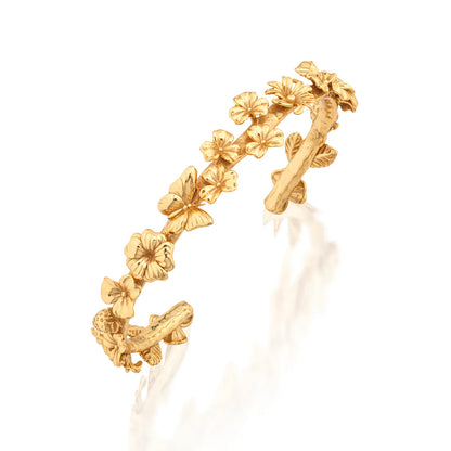 Gold floral ring on a white background
