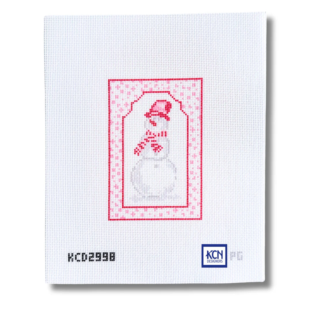 A white needlepoint canvas featuring a stitched snowman design in red and gray, framed by a red patterned border. The canvas includes the printed code 'KCD2998' on the bottom left and the 'KCN' brand logo on the bottom right.