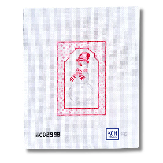 A white needlepoint canvas featuring a stitched snowman design in red and gray, framed by a red patterned border. The canvas includes the printed code 'KCD2998' on the bottom left and the 'KCN' brand logo on the bottom right.