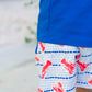 Blue and white shorts with red lobster pattern