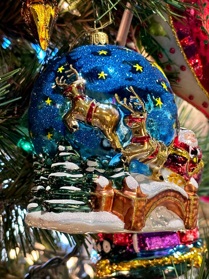 Decorative Christmas ornament with reindeer and sleigh on a tree