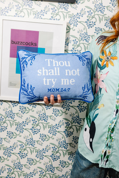 A blue needlepoint pillow with the text 'Thou shall not try me' and the Bible verse 'MOM 24:7' embroidered on it