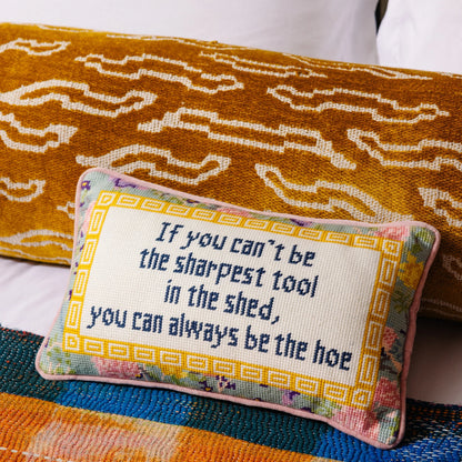 Decorative pillow with text on a colorful fabric background