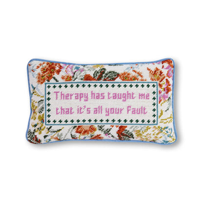 Decorative pillow with floral pattern and text on a white background