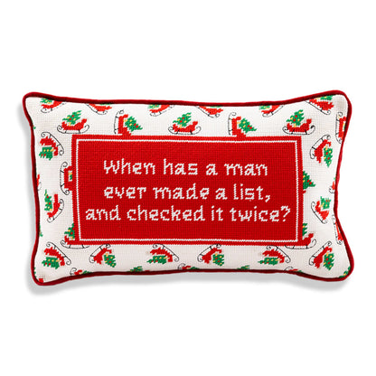 Decorative pillow with Christmas-themed border and humorous quote on a white background