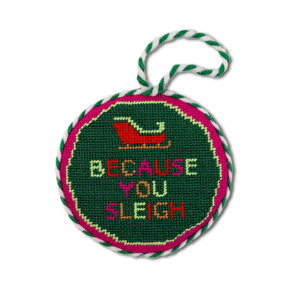 Round needlepoint ornament with 'Because You Sleigh' text and Santa sleigh design on a green background.